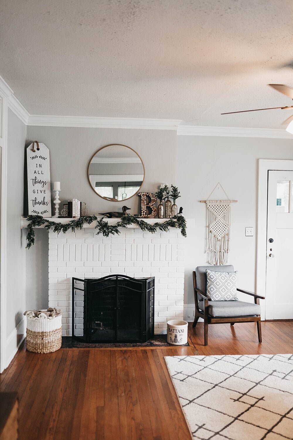 white fireplace in a living room with brown hardwood floor from Mendel Carpet & Flooring in Indianapolis, IN