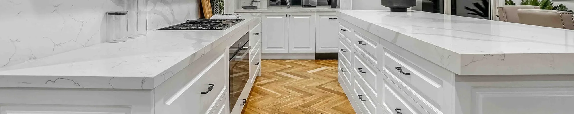 hardwood flooring in kitchen with white countertops